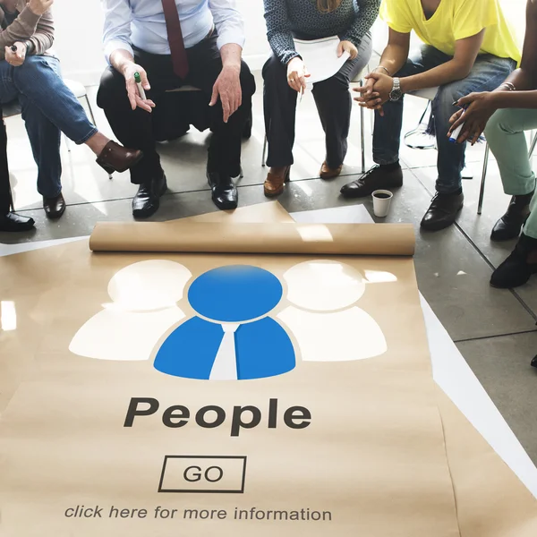 People sitting in circle over poster — Stock Photo, Image