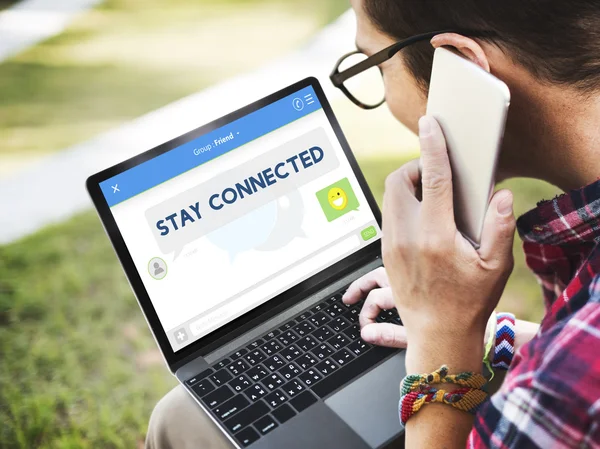 Joven con portátil y smartphone — Foto de Stock