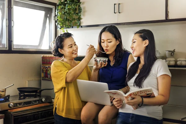 asian mother with daughters cooking