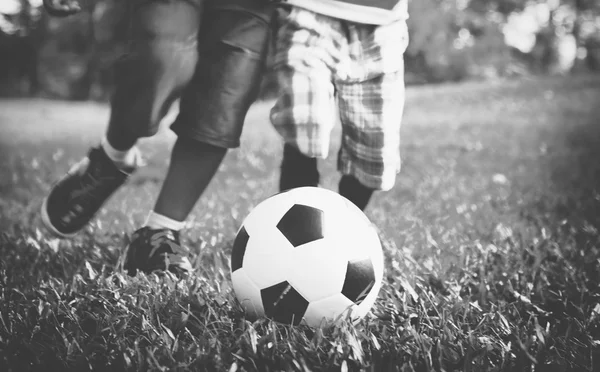 Children playing football in summer park — Stock Photo, Image