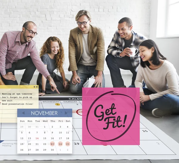 Diseñadores trabajando con póster y Get Fit — Foto de Stock