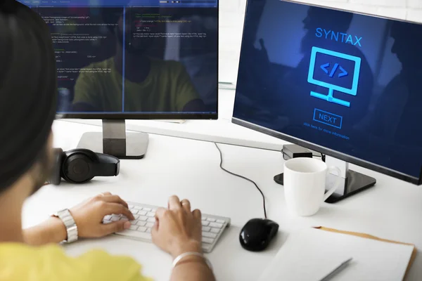 Businessman working on computer with syntax — Stock Photo, Image