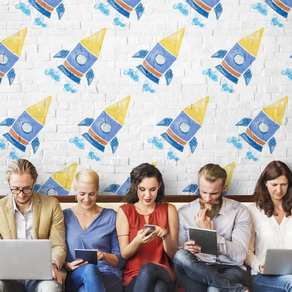 People sit with devices and rockets — Stock Photo, Image