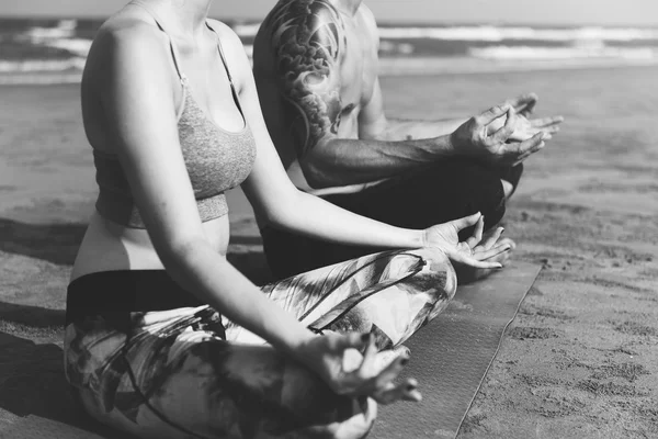 Koppel doen yoga op het strand — Stockfoto