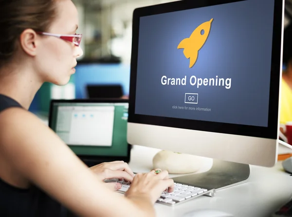 Businesswoman working on computer with Grand Opening — Stock Photo, Image