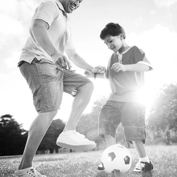 Father playing football with little son — Stock fotografie