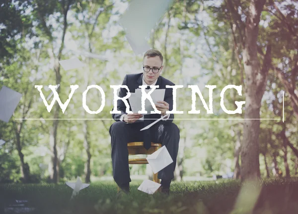 Businessman with case in park — Stock Photo, Image