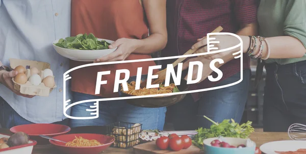 Friends cooking in kitchen — Stock Photo, Image