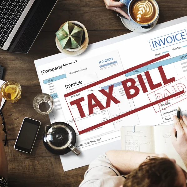 Table with poster with tax bill — Stock Photo, Image