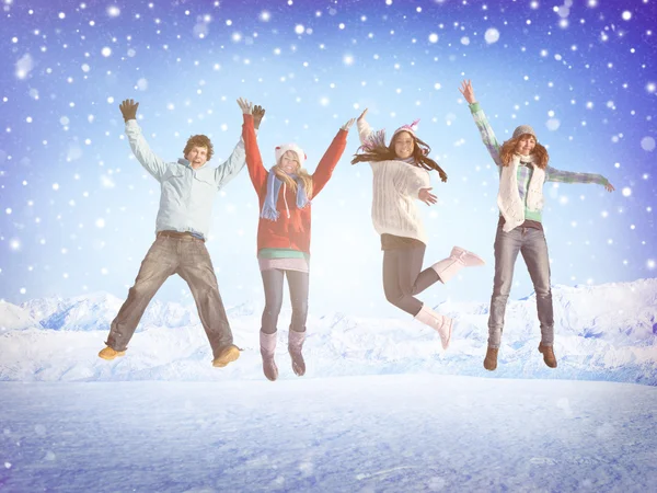 Friends jumping in snow — Stock Photo, Image