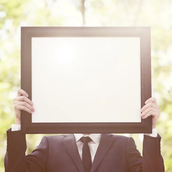 Businessman holding information desk — Stock Photo, Image