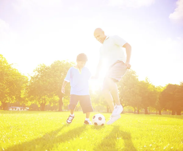 Father playing football with little son — Stockfoto