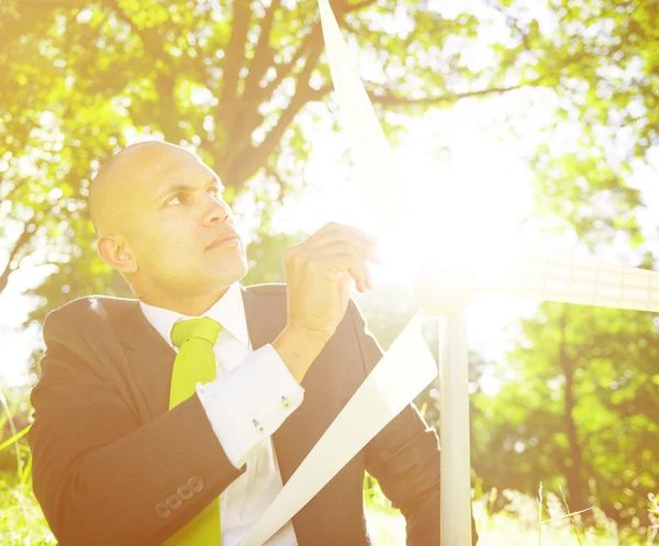 Businessman holding wind turbine — Stock Photo, Image