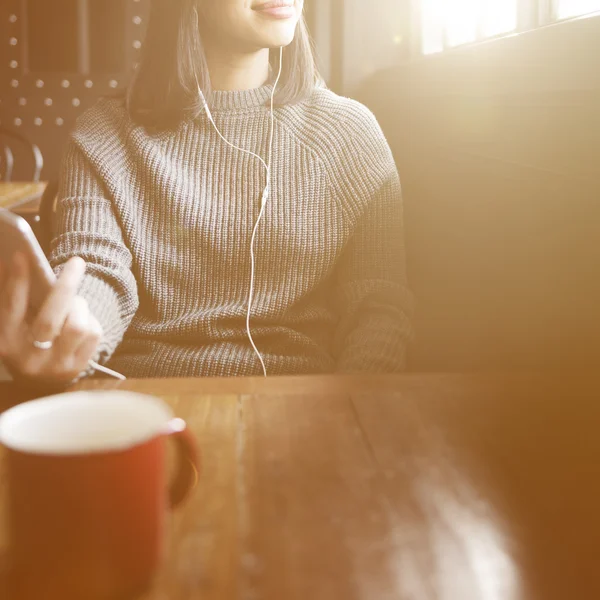 Kobieta ze słuchawkami w kawiarni — Zdjęcie stockowe