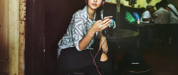 Mujer escuchando música en la cafetería — Foto de Stock