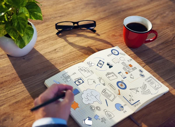 Businessman writing in notebook — Stock Photo, Image