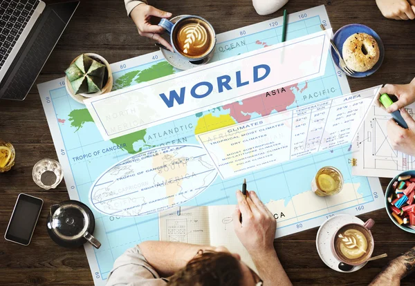 Table with poster with world — Stock Photo, Image