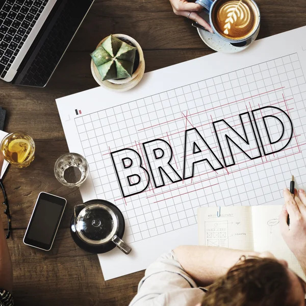 Table with poster with Brand — Stock Photo, Image