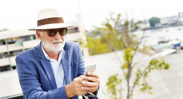 Senior man med mobiltelefon — Stockfoto