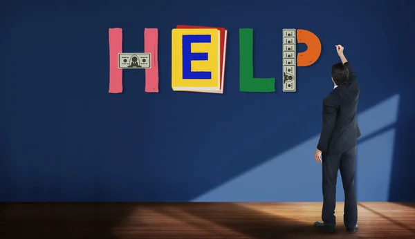 Businessman stands near wall — Stock fotografie