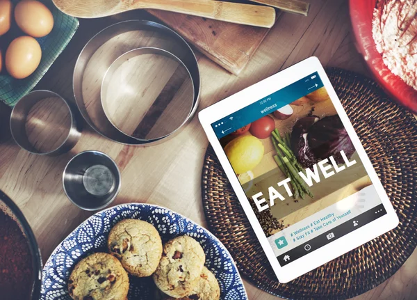 Digital tablet on kitchen table — Stock Photo, Image