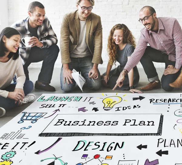 Designers working with poster and business plan — Stock Photo, Image