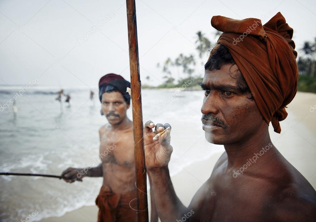 Fisherman smoking by shore