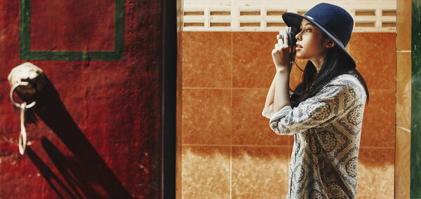 beautiful girl in hat with photo camera