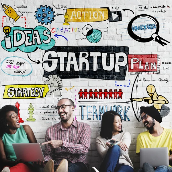 Diversity friends near wall with startup — Stock Photo, Image