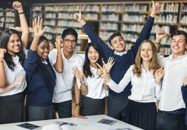 Happy students in university library — Stock Photo, Image