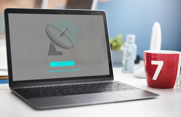 Laptop and red mug on table — Stock Photo, Image