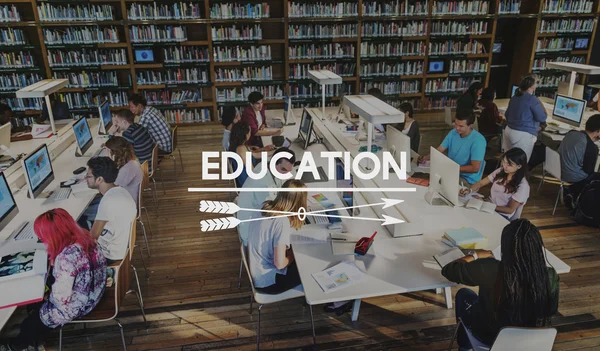 Students using computers in university library — Stock Photo, Image