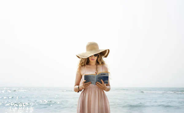 Vrouw die boek leest op het strand — Stockfoto