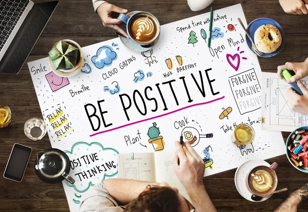 Table with poster with be positive — Stock Photo, Image