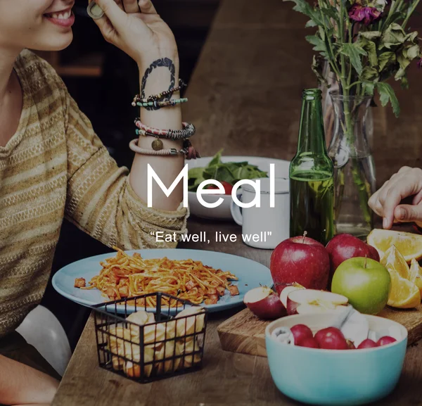 Smiling woman eating in cafe — Stock Photo, Image