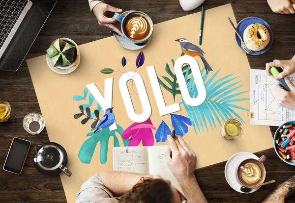 Table with poster with yolo — Stock Photo, Image