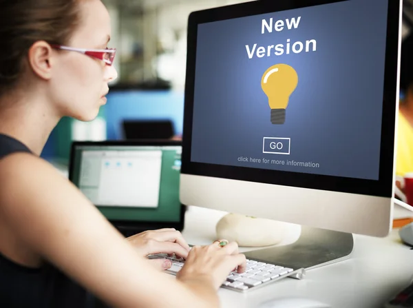 Businesswoman working on computer with New Version — Stock Photo, Image