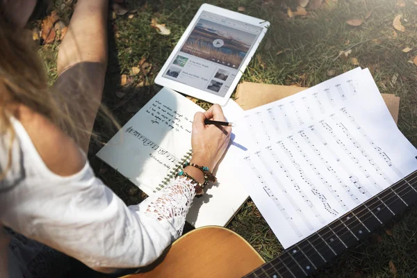 Дівчина пише пісню в парку — стокове фото