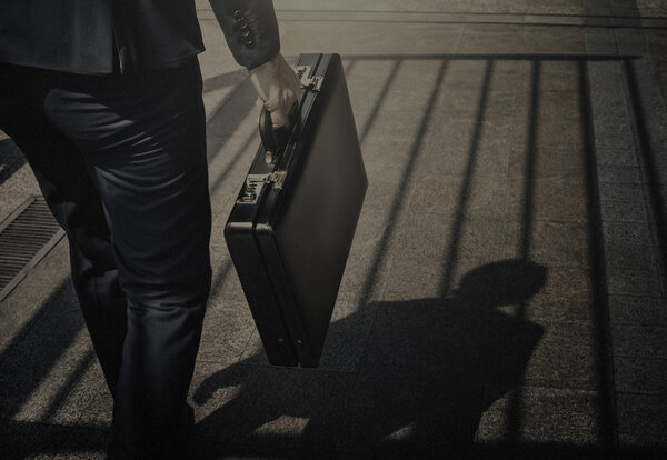 businessman walking with suitcase