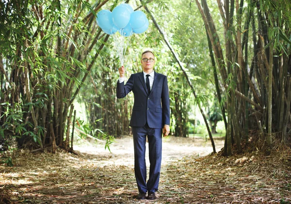 Handsome Businessman with balloons — Stock Photo, Image