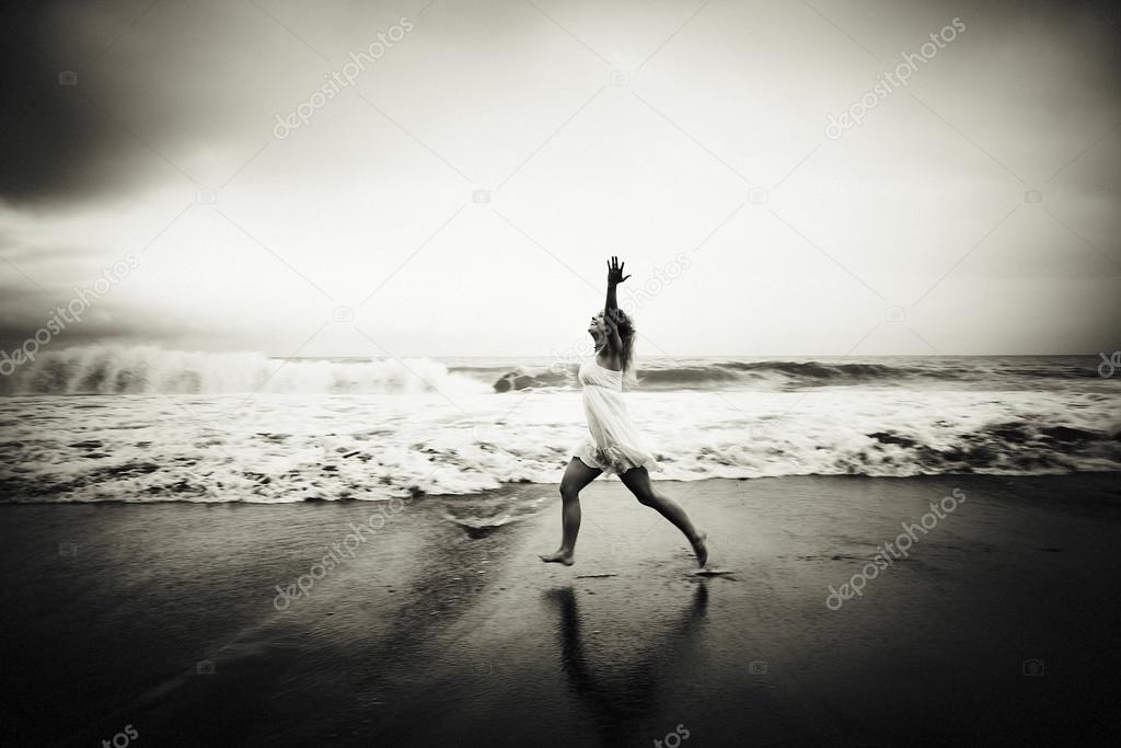 Woman runninh at ocean beach