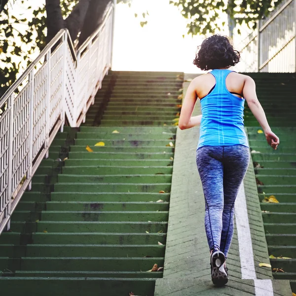 Sportive woman running upstairs — Stock Photo, Image