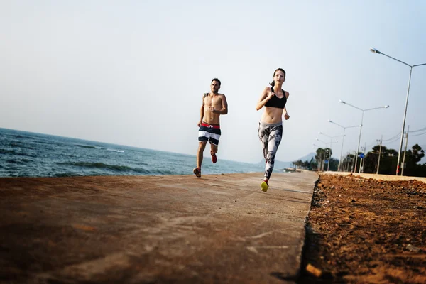 People doing sport exercises at beach