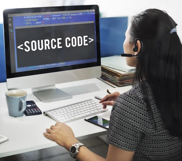 Business woman working on computer with source code — стоковое фото