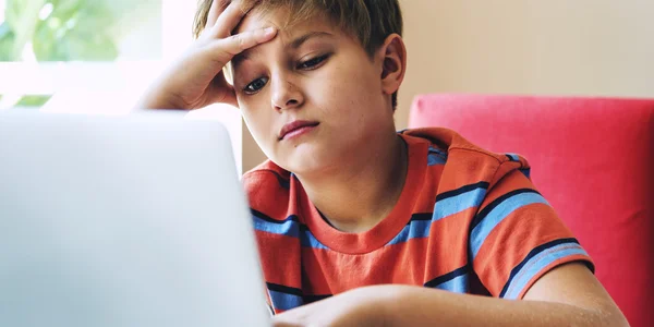 Unhappy Boy playing on Computer — Stock Photo, Image