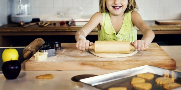 Girl kneading dough for cookies — Stock Photo, Image