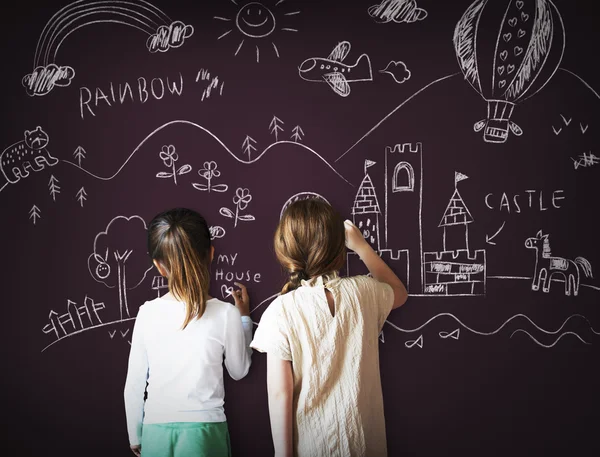 Kids drawing on blackboard — Stock Photo, Image