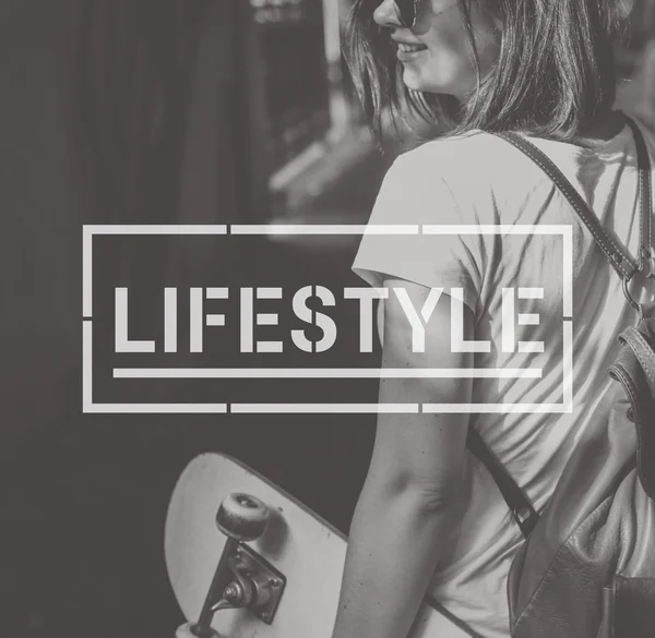Молодая женщина со скейтбордом в руке — стоковое фото