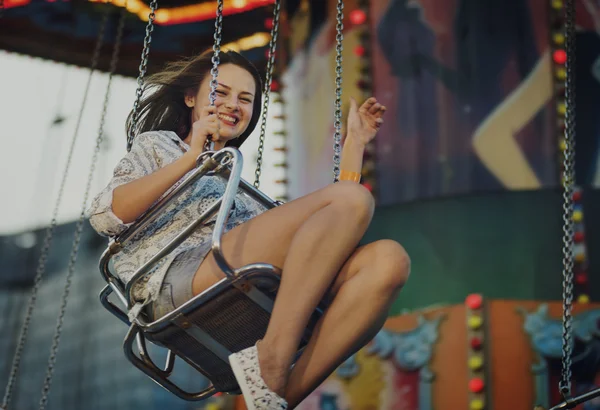 Girl riding on swing in Amusement Park — Stock Photo, Image