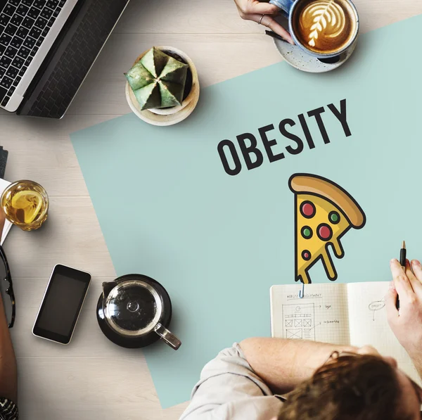 Table with poster with obesity concept — Stock Photo, Image